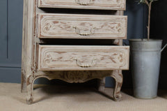 French-style tall drawers with distressed beige paint and carved detailing