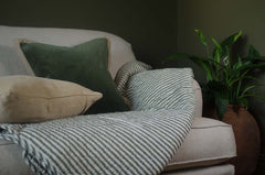 Beige sofa with green velvet cushions, and ib laursen quilted hrow