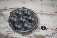 Vintage indian stone tealight holder metal objects on a rustic wooden surface