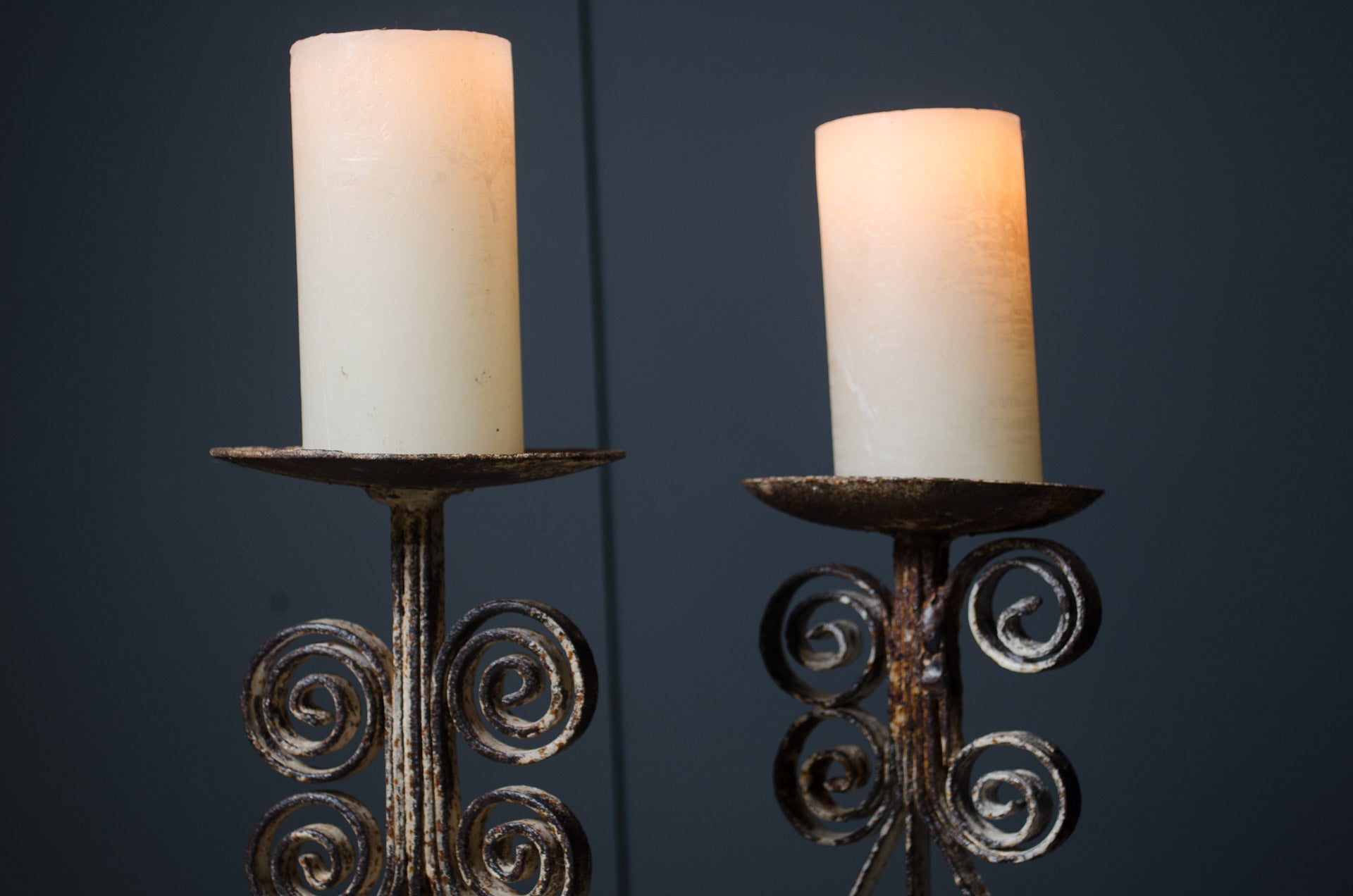 
Two candle holders with candles on a dark background