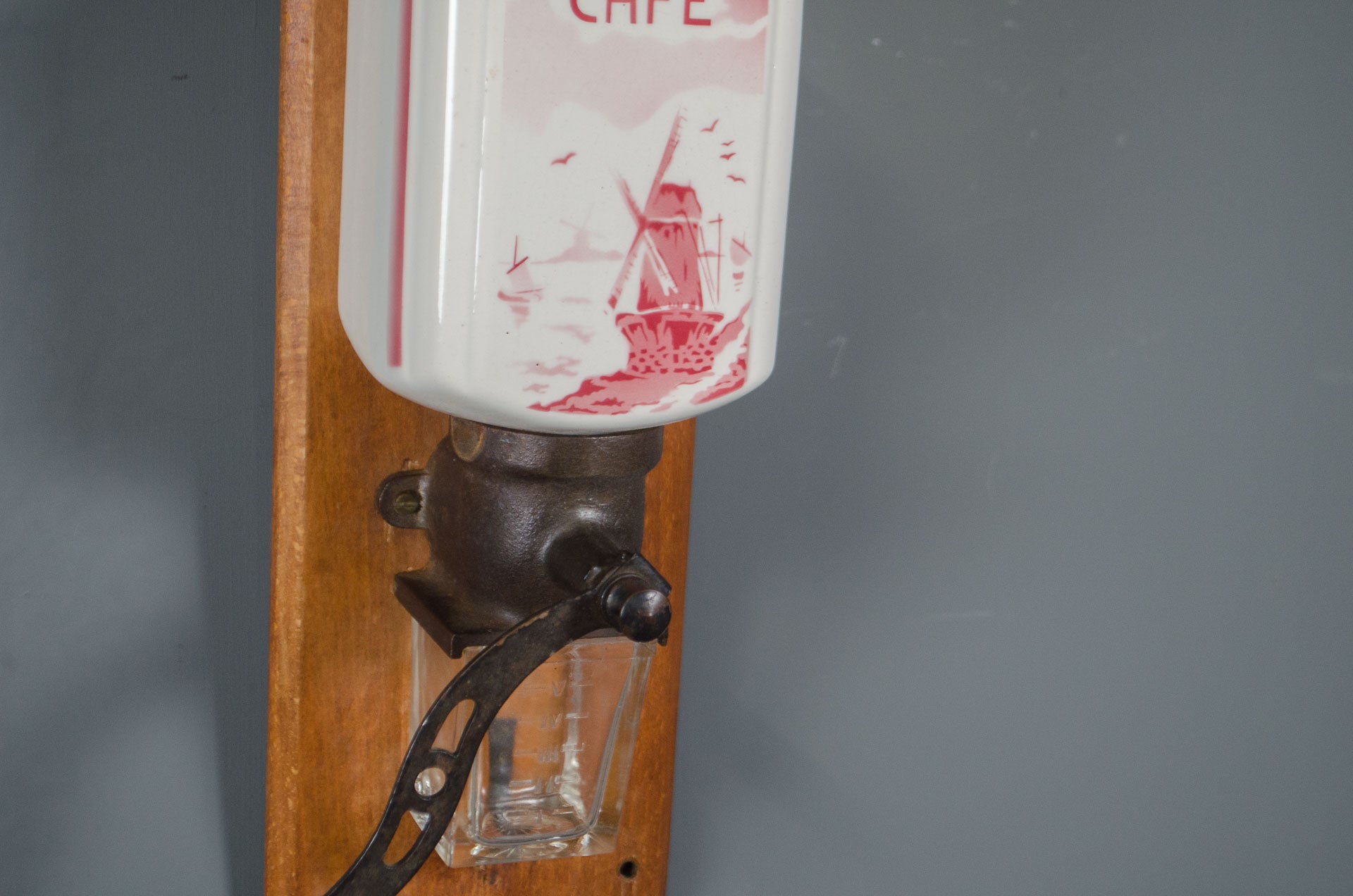 
French wall coffee mill with hand crank and glass container