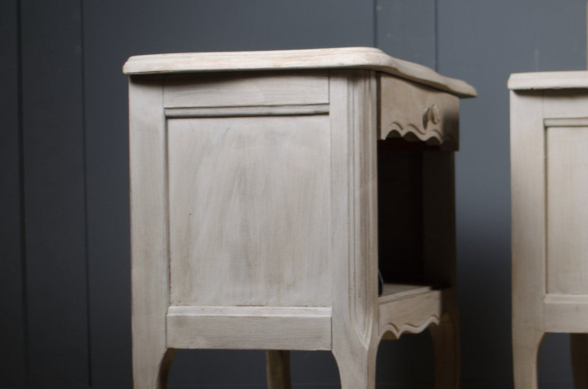 
Distressed grey French bedside tables with elegant curved detailing