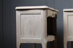 Distressed grey French bedside tables with elegant curved detailing

