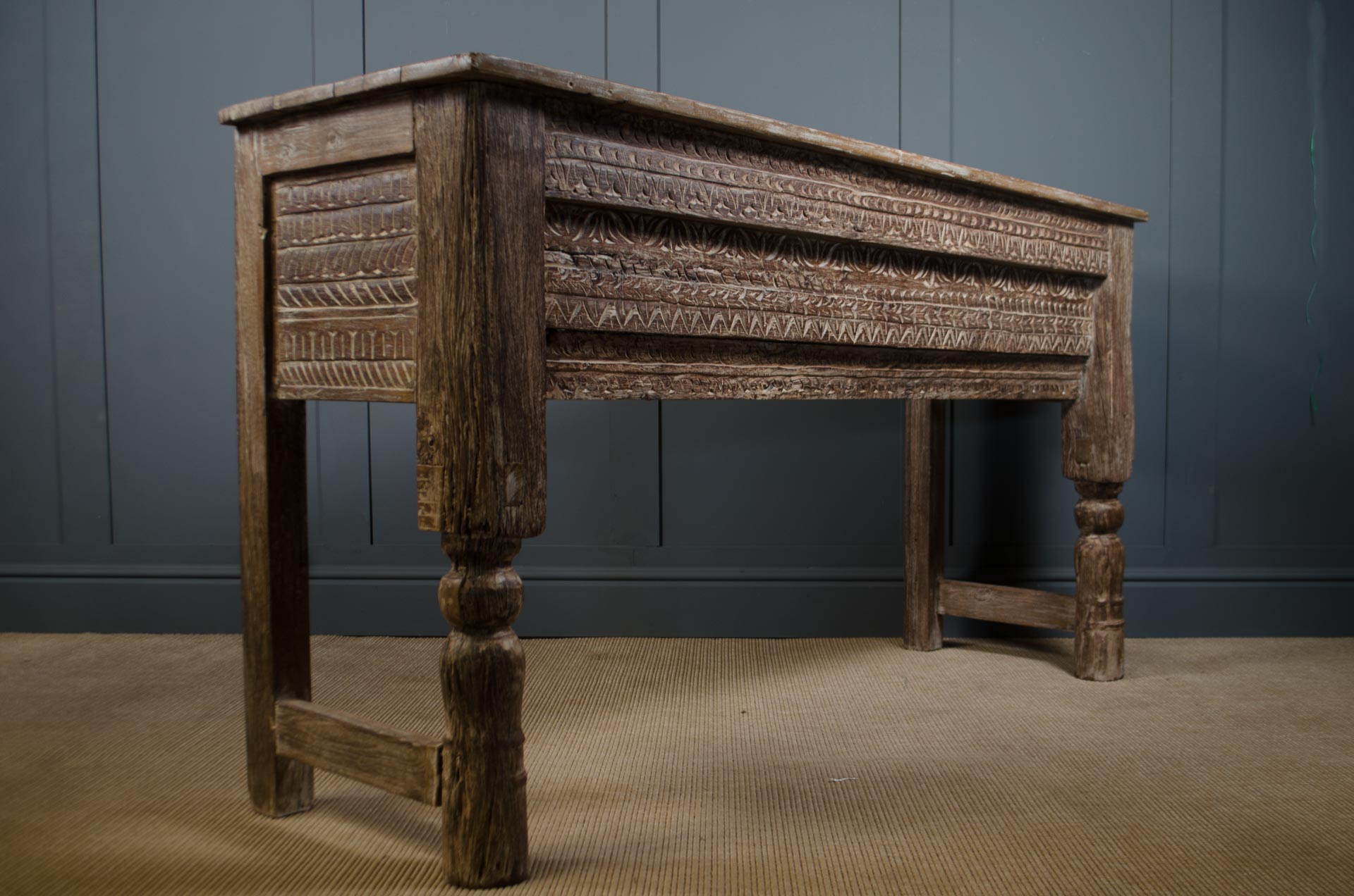 Rustic carved teak console table from India with turned legs and decorative apron