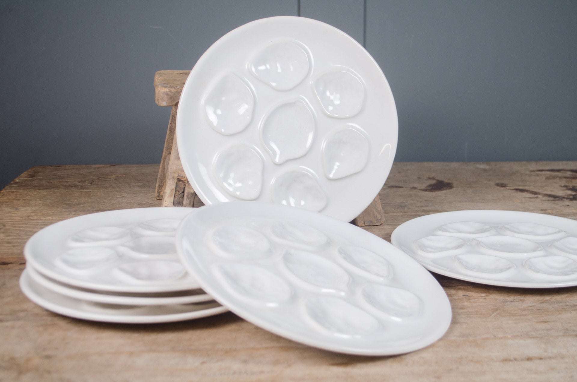 ironstone French white glazed oyster plate with six oyster wells and central lemon compartment.