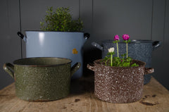 Vintage enamel buckets with two side handles and speckled enamel finish.