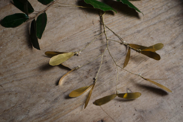 Brass foil leaf cluster Christmas decoration on twisted wire”