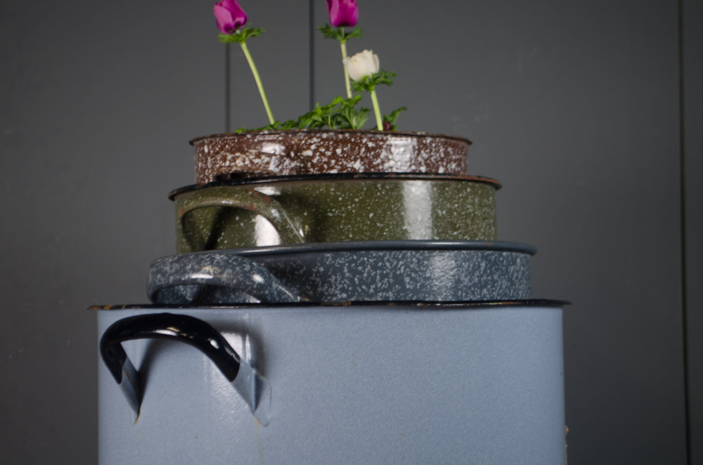 Speckled enamel metal buckets with vintage patina.