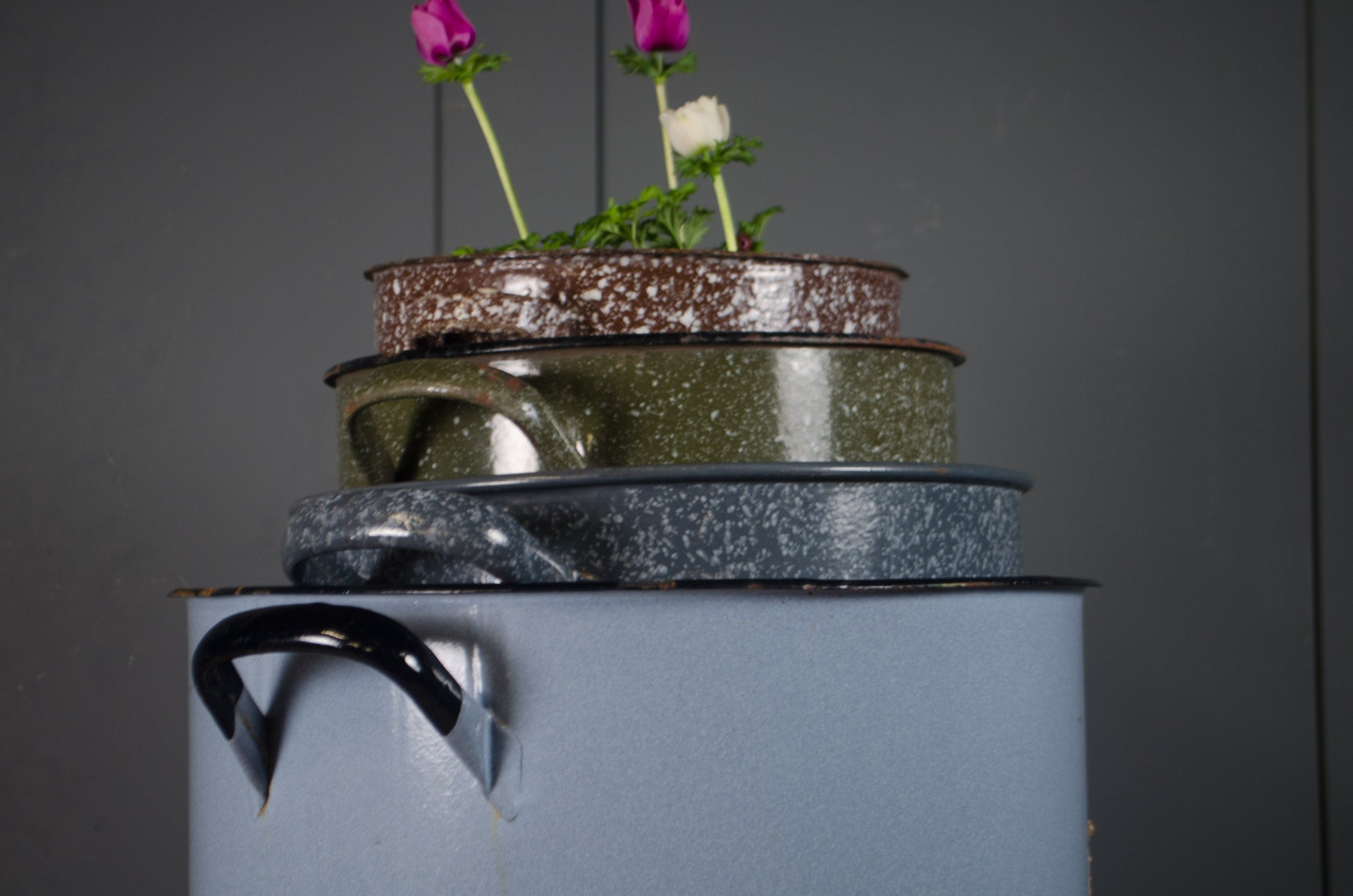 Rustic enamelware buckets suitable for planters or storage.