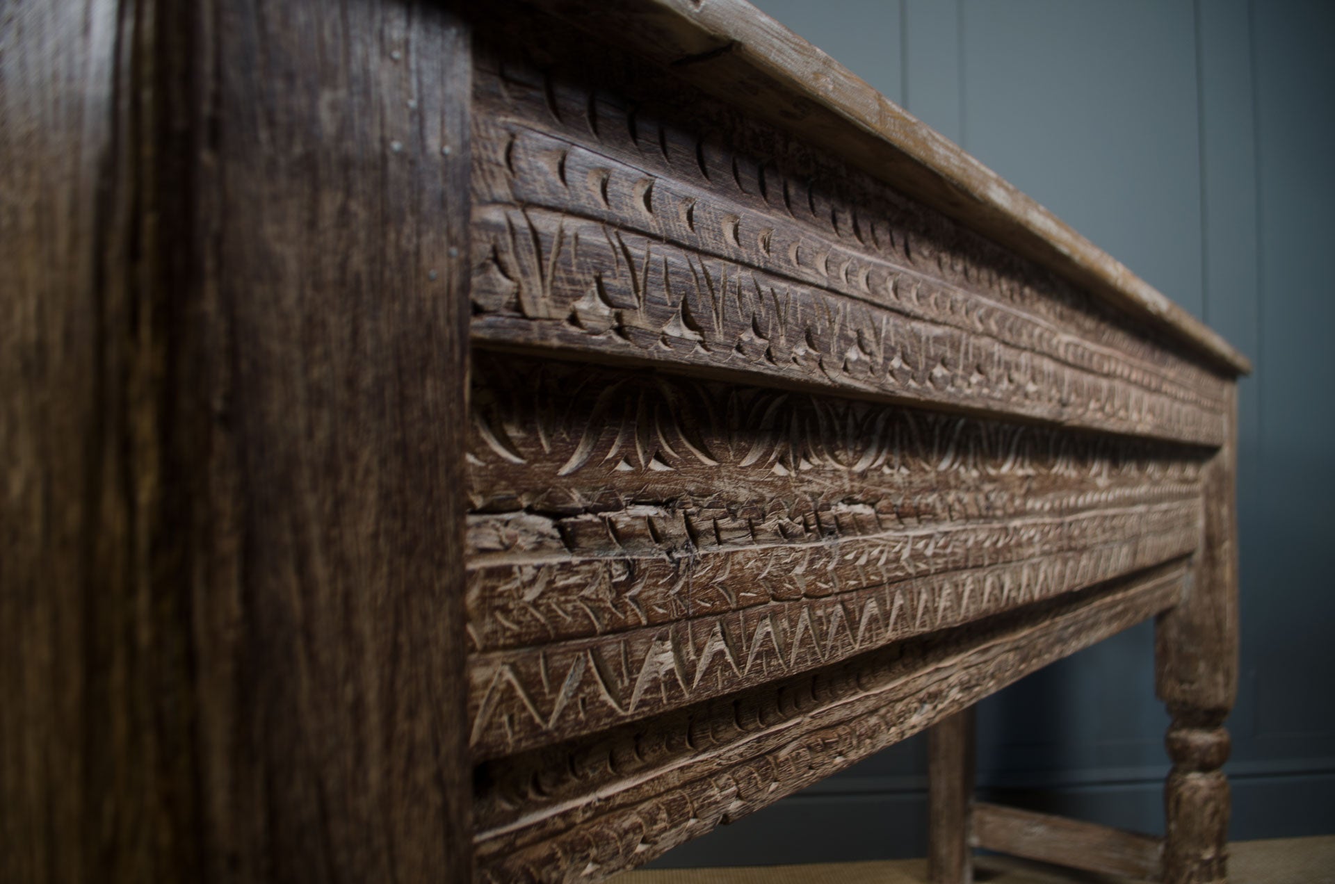 
Vintage Indian teak console table featuring detailed hand carvings and aged natural finish
