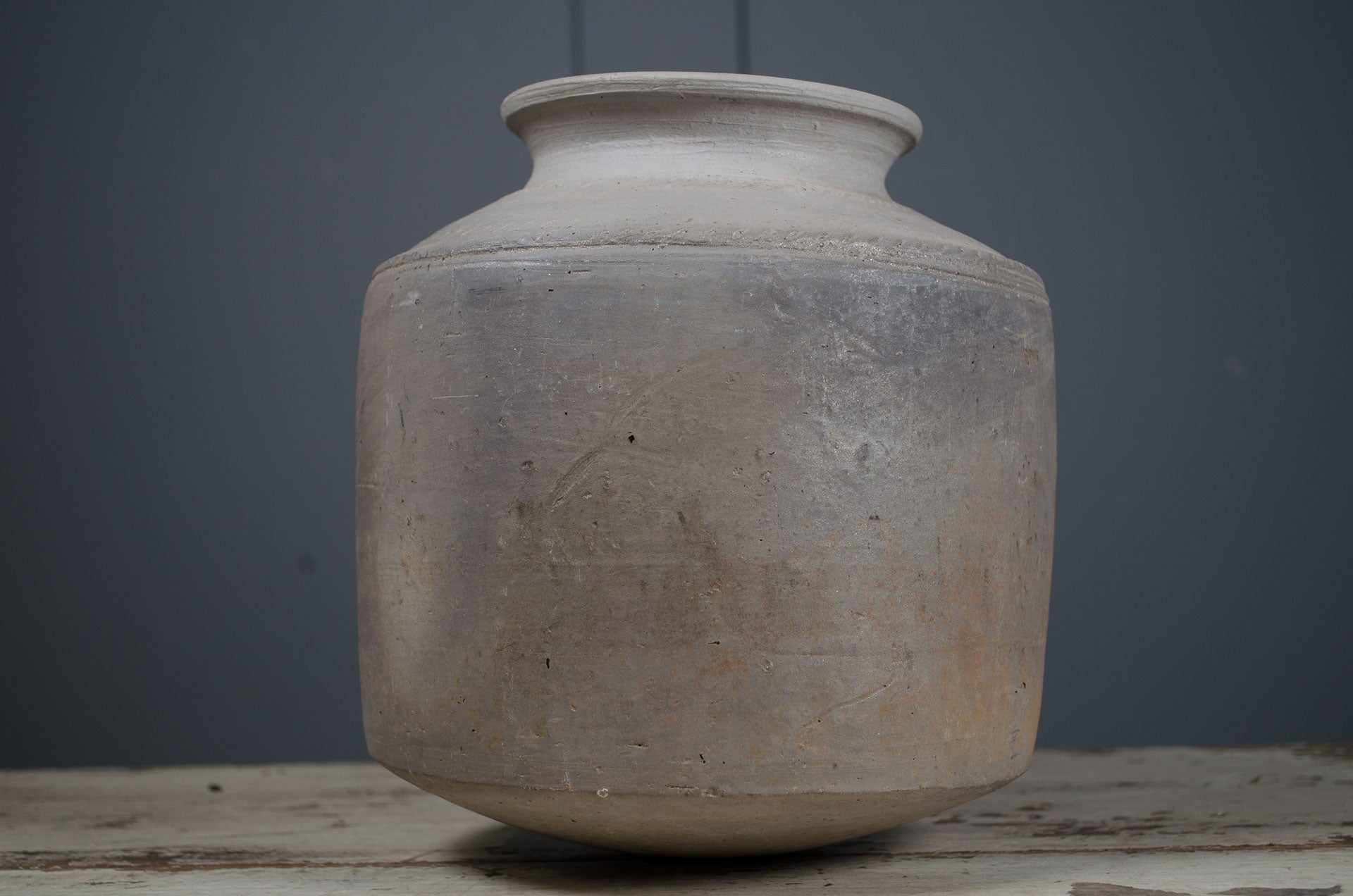 
hand-thrown water pot, grey ceramic vase, curved bottom pot, rustic clay vessel, handmade pottery vase, textured ceramic decor, dried flower vase, sculptural ceramic pot, wabi-sabi pottery, minimalist ceramic home decor