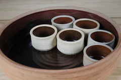 Rustic French stoneware salad bowl and six ramekins with unique black reactive glaze interior.