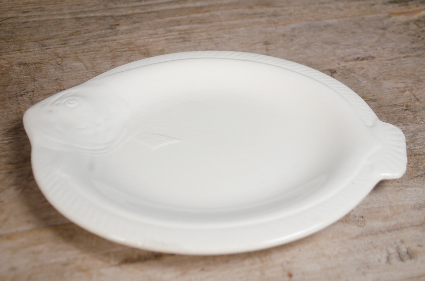 Vintage Longwy French fish-shaped plate in a white glaze with age-related crazing and matching platter available.