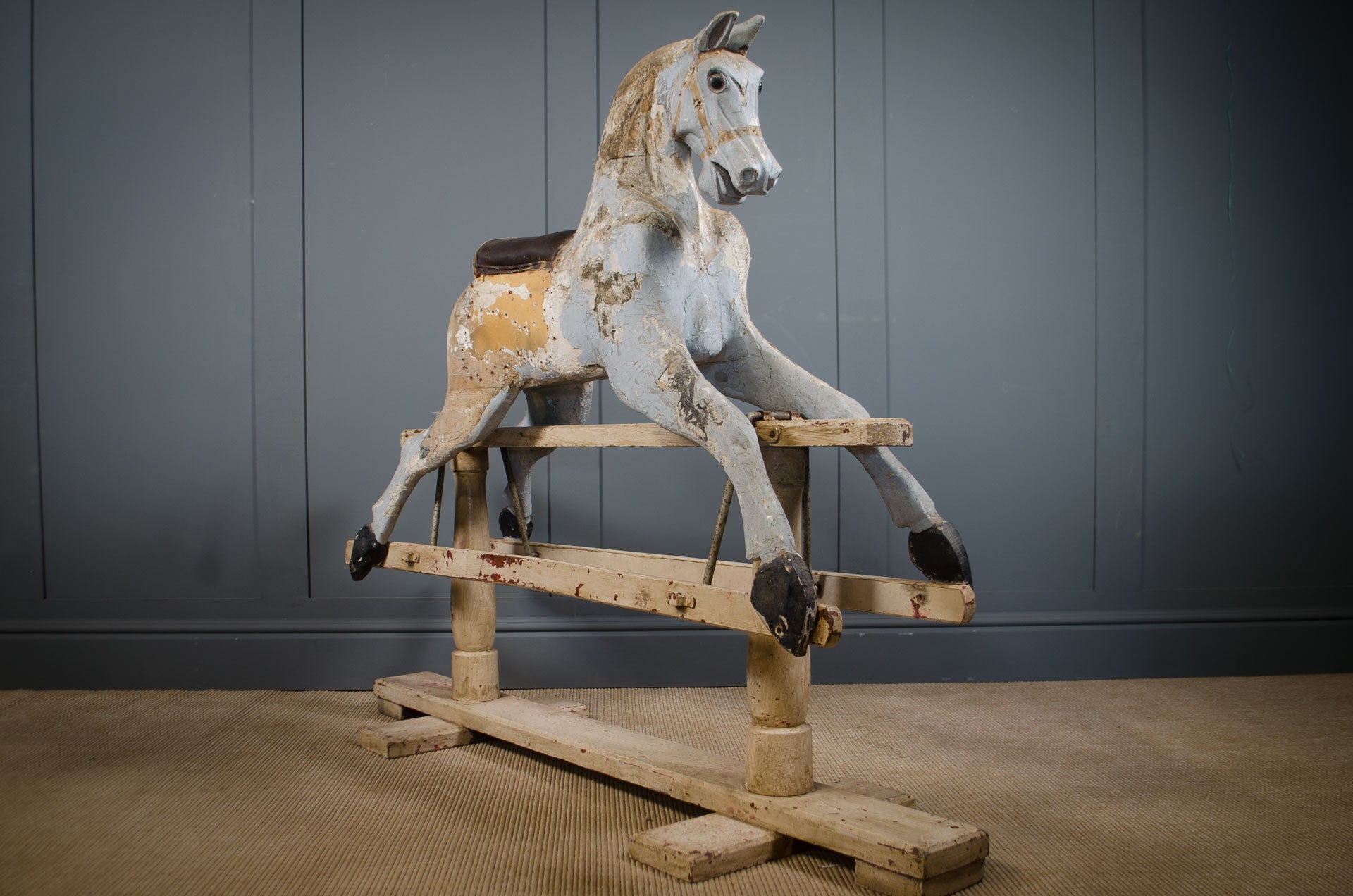 Original Victorian rocking horse with chippy paint on wooden stand