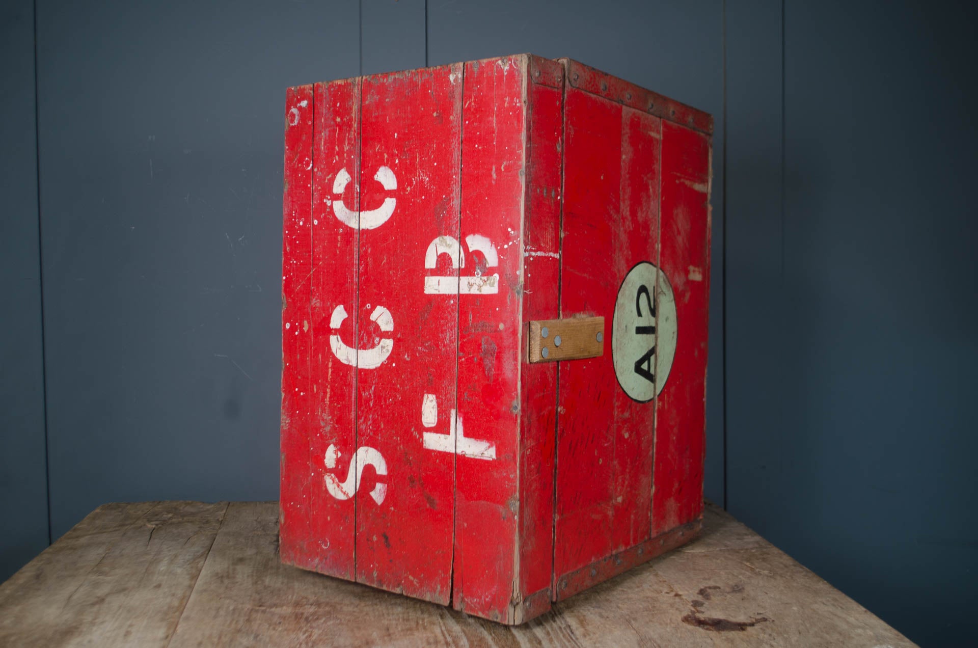 
Red painted wooden chest with lift-up lid and iron handles