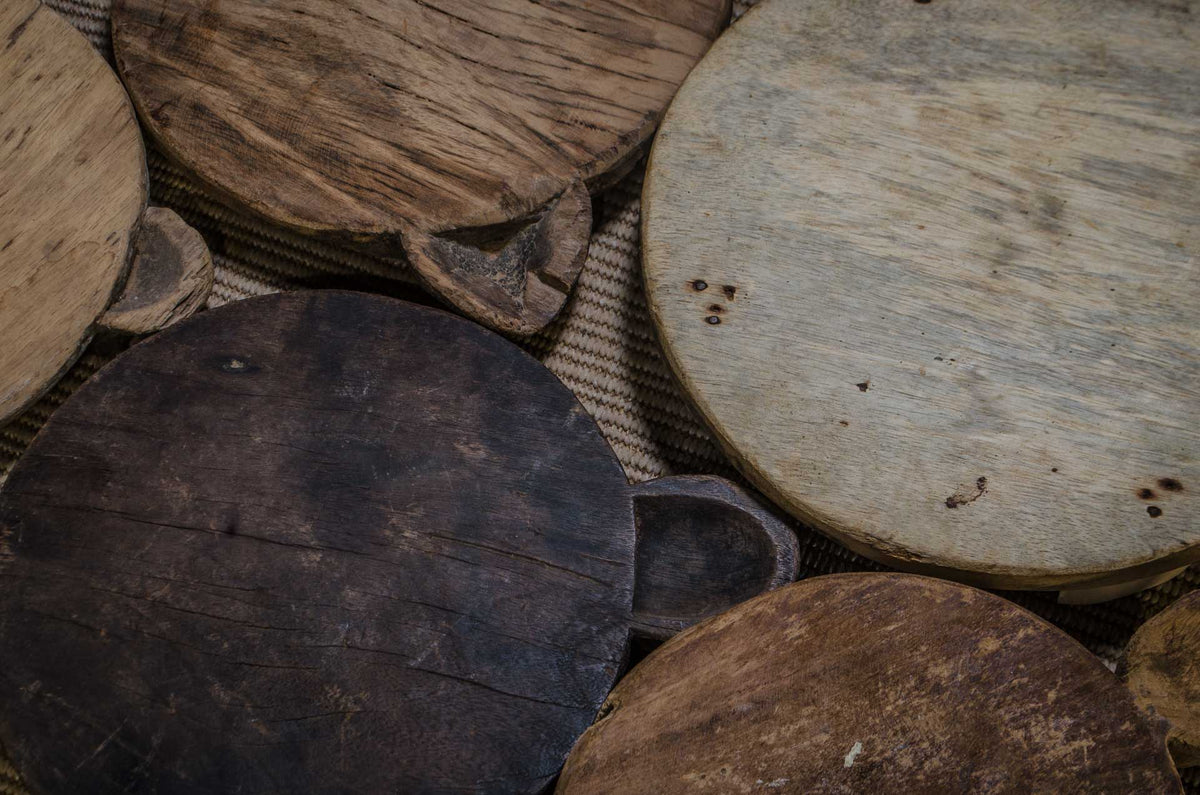
Rustic wooden chapati board used as kitchen oil and spice stand