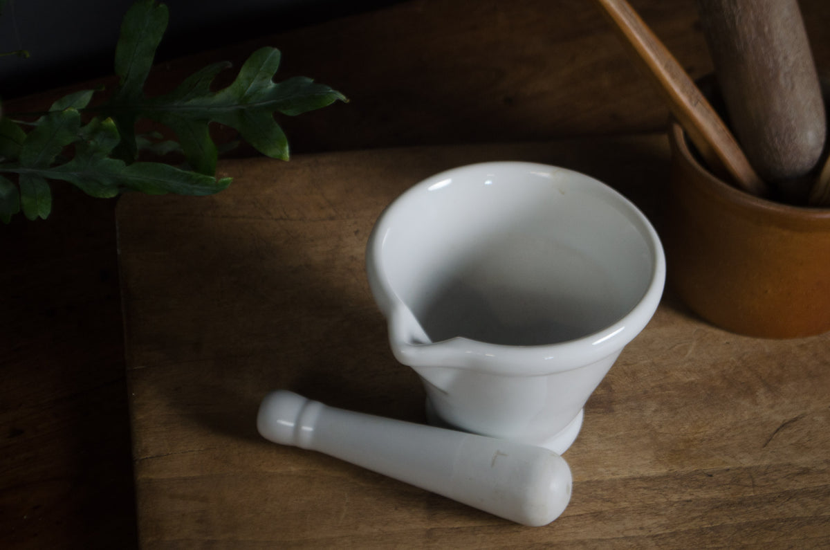
- Large white ceramic mortar and pestle for kitchen display