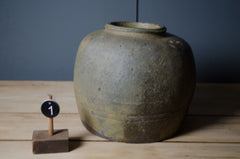 Vintage Chinese stoneware preserve jars with rustic patina and traditional glaze finishes.