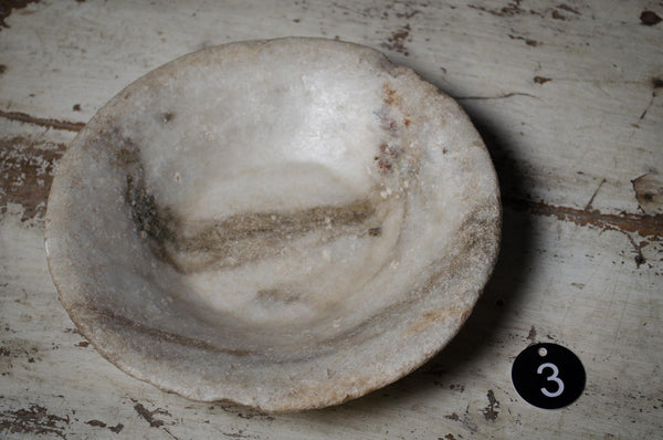 Vintage ceramic marble bowl on a textured surface kitchen