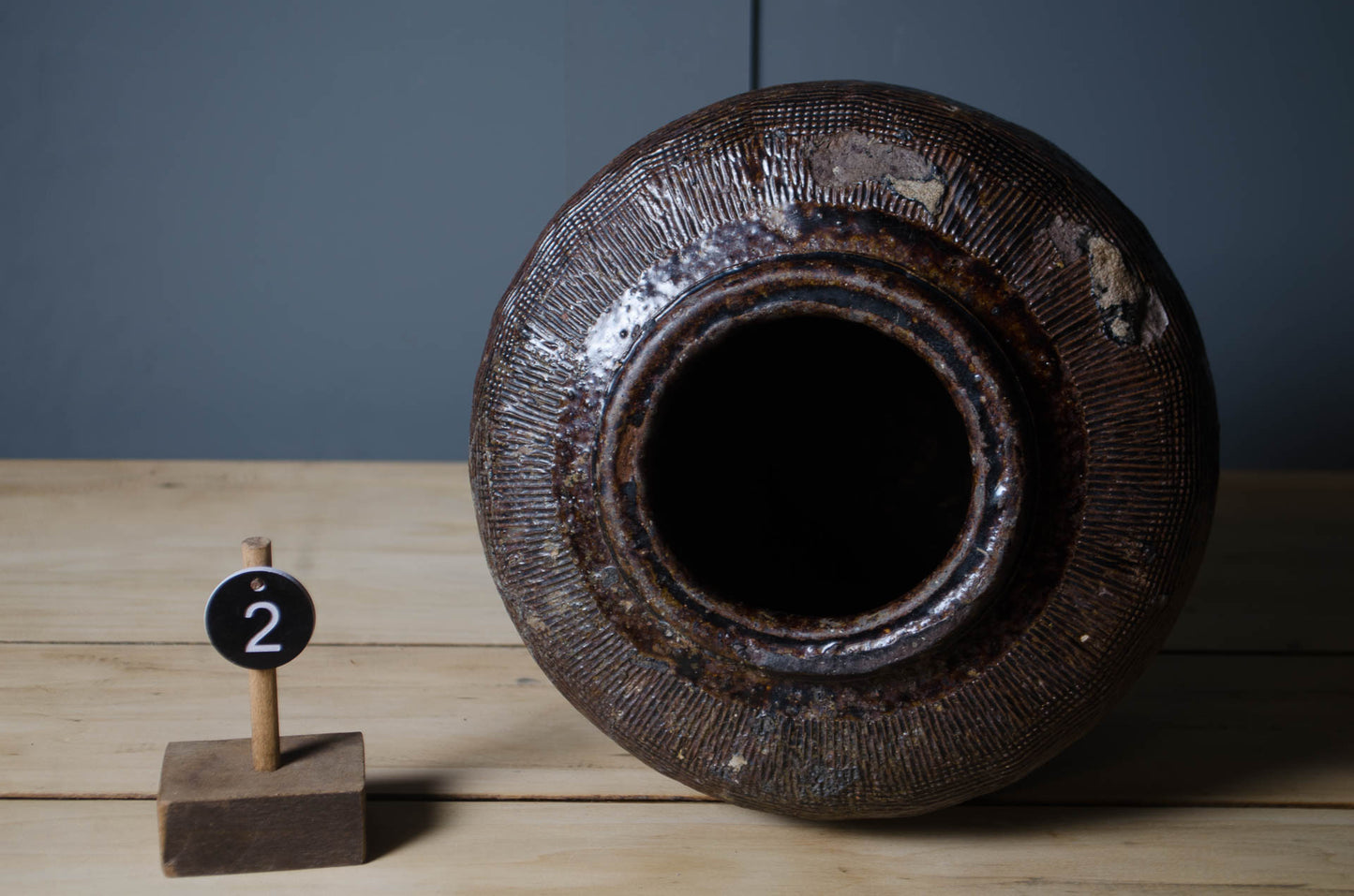 Selection of authentic Chinese preserve jars featuring aged olive and brown ceramic glazes.