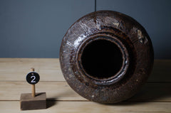 Selection of authentic Chinese preserve jars featuring aged olive and brown ceramic glazes.