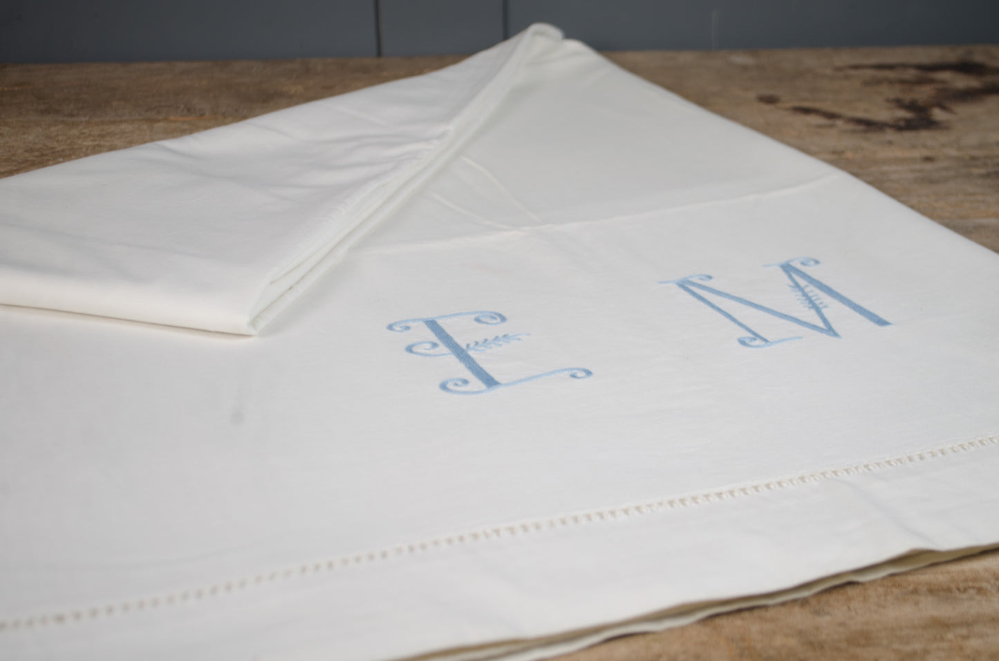Antique French heavyweight linen sheet with embroidered initials  and decorative border detailing.