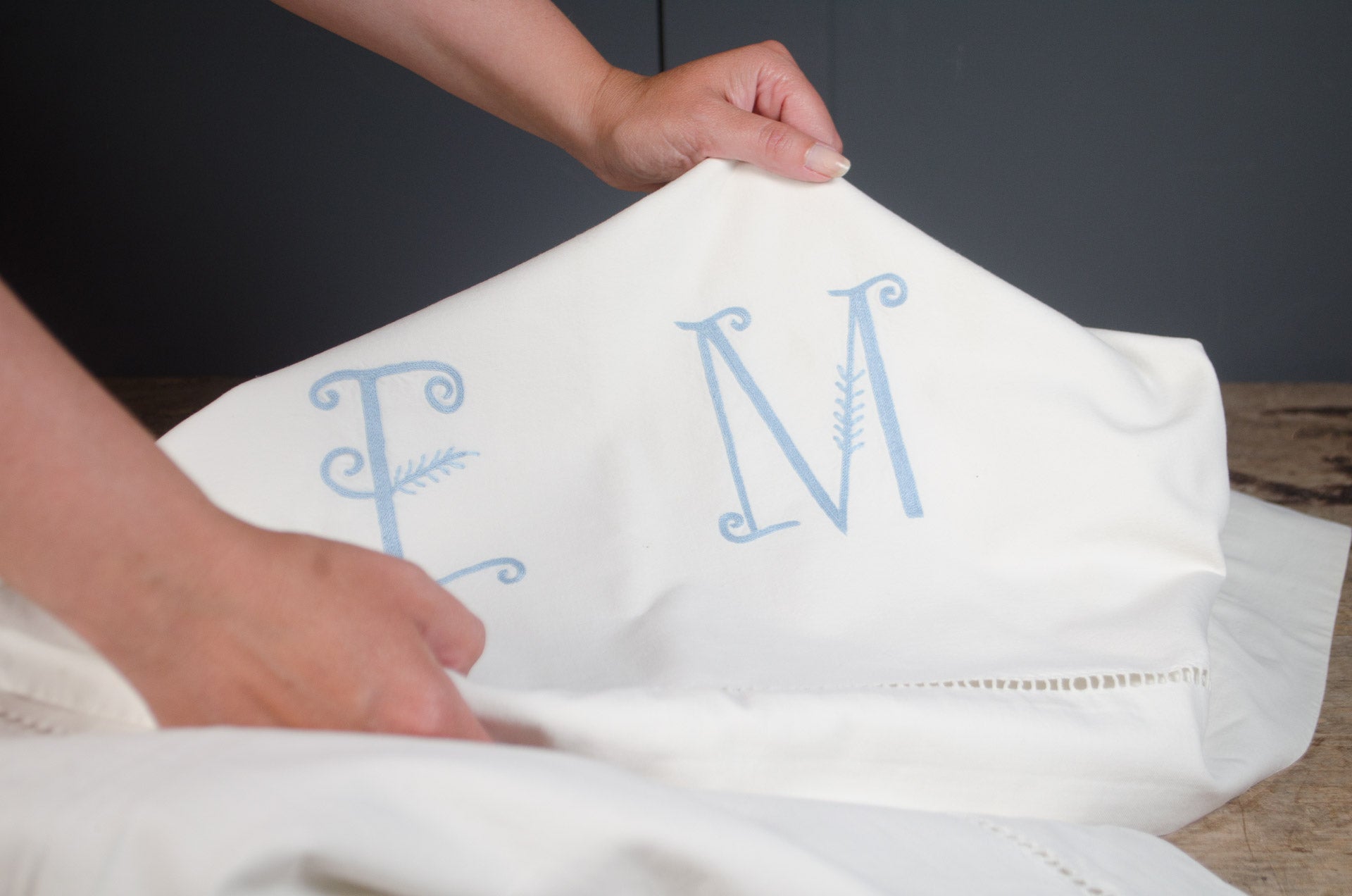 
Antique French heavyweight linen sheet with embroidered monogram and decorative border detailing.