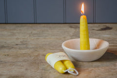 beeswax candle in stone bowl