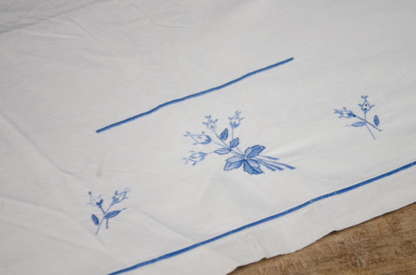 Antique French heavyweight linen tablecloth with blue flower embroidery