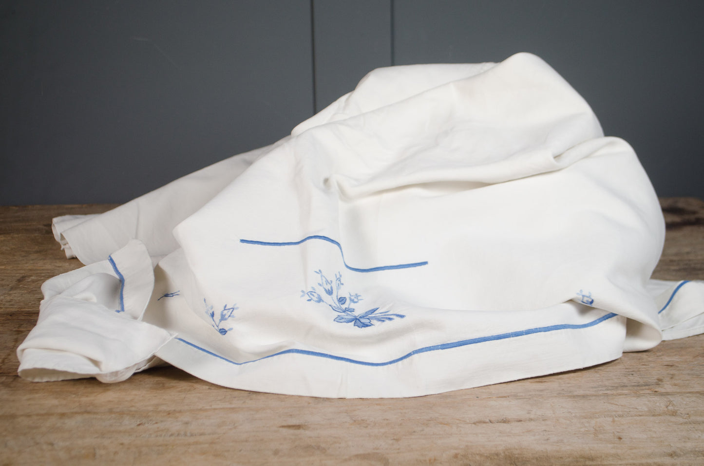 Antique French heavyweight linen tablecloth with blue flower embroidery
