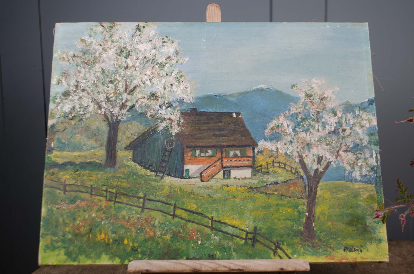 French pastoral landscape artwork displayed on wooden easel