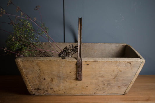 Worn wooden harvesting trug with iron carrying handle
