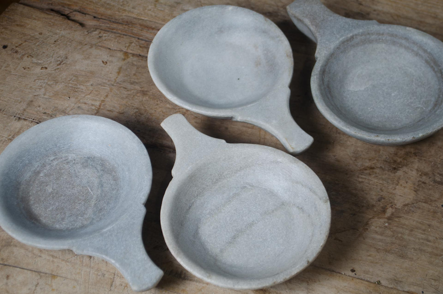 indian marble bowl in grey on a rustic wood table