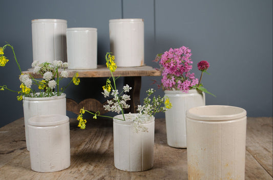 Rustic antique preserve pots with aged cream glaze