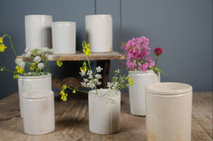 Rustic antique preserve pots with aged cream glaze