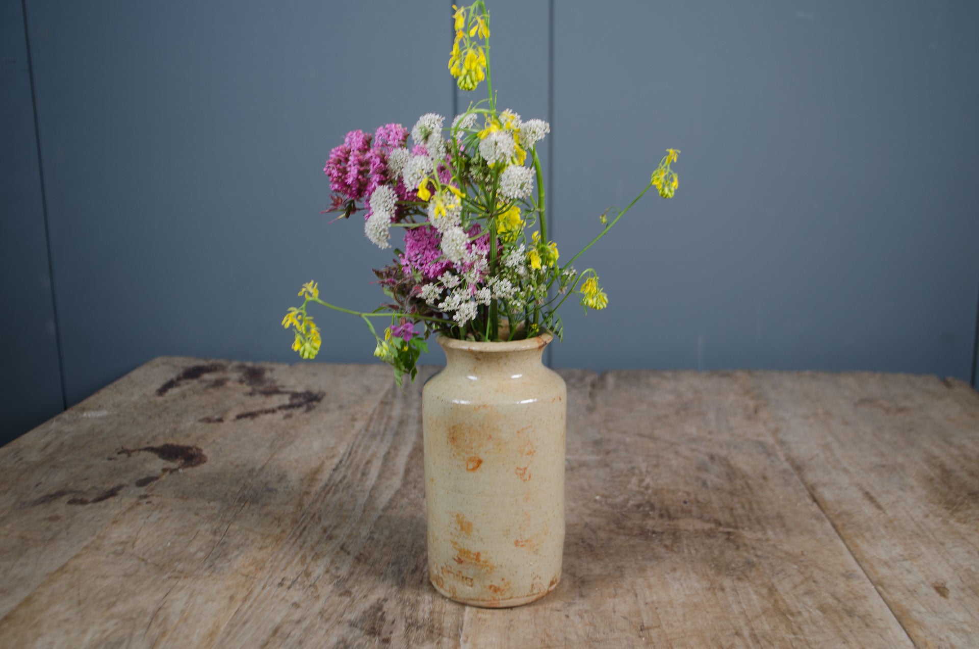 Rustic English ink bottle on wooden farmhouse table

