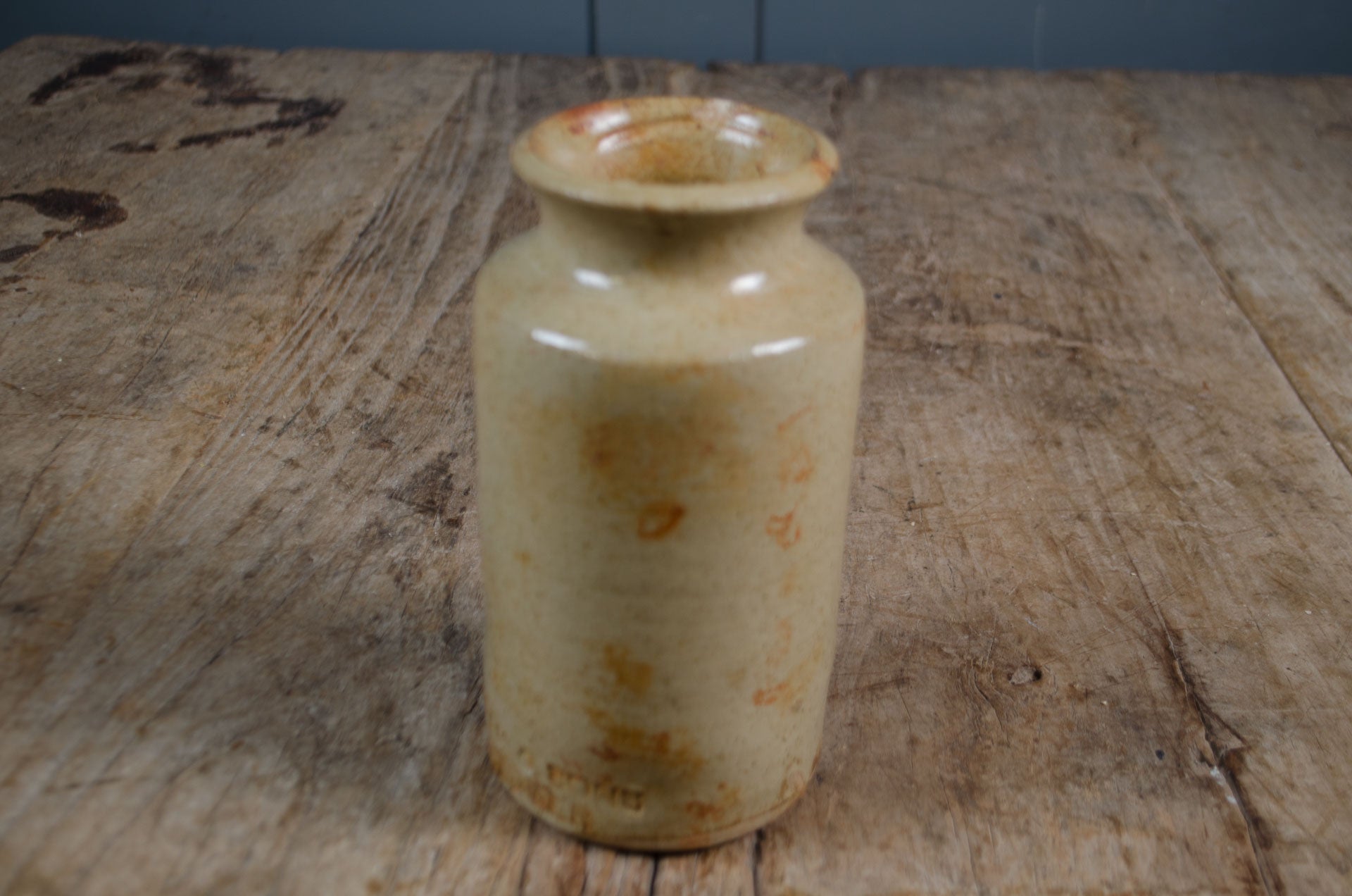 Rustic cream glazed antique ink bottle with aged patina