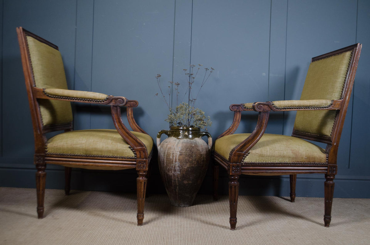 Pair of sage green compact French upholstered armchairs with fluted legs
