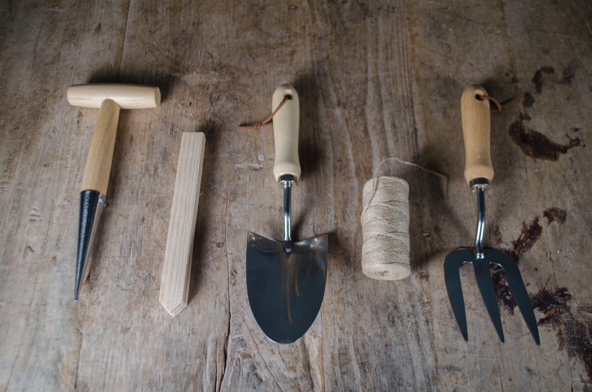 
Set of gardening tools on a wooden surface