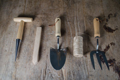 Set of gardening tools on a wooden surface