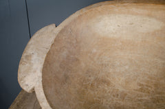 Close-up of a large wood bowl with a textured surface against a dark background