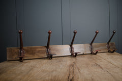 Vintage wall mounted coat hooks on wooden board