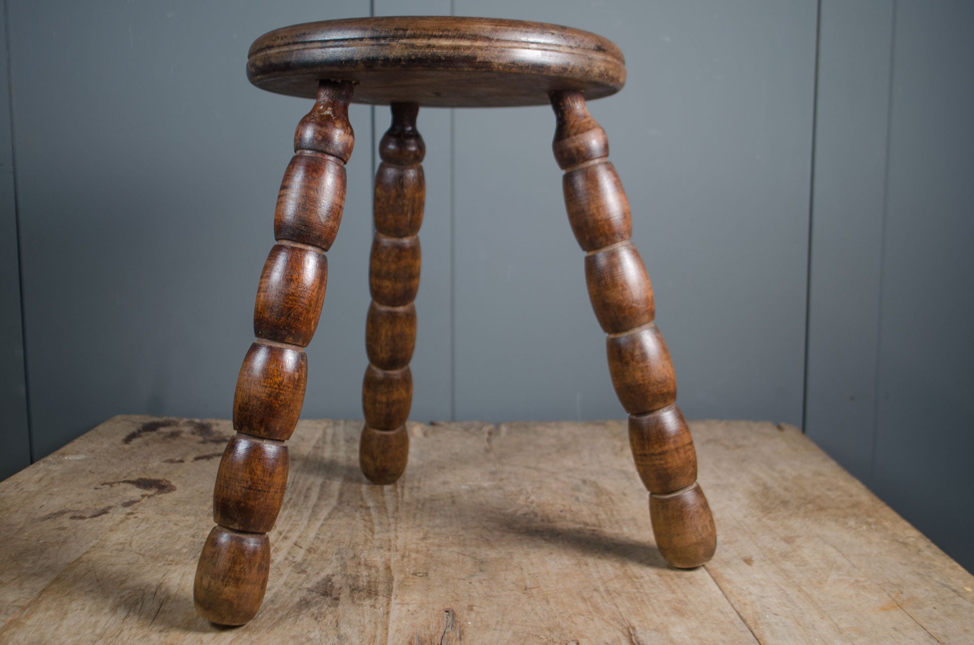 
Antique French wooden stool with circular button top and bobbin turned legs