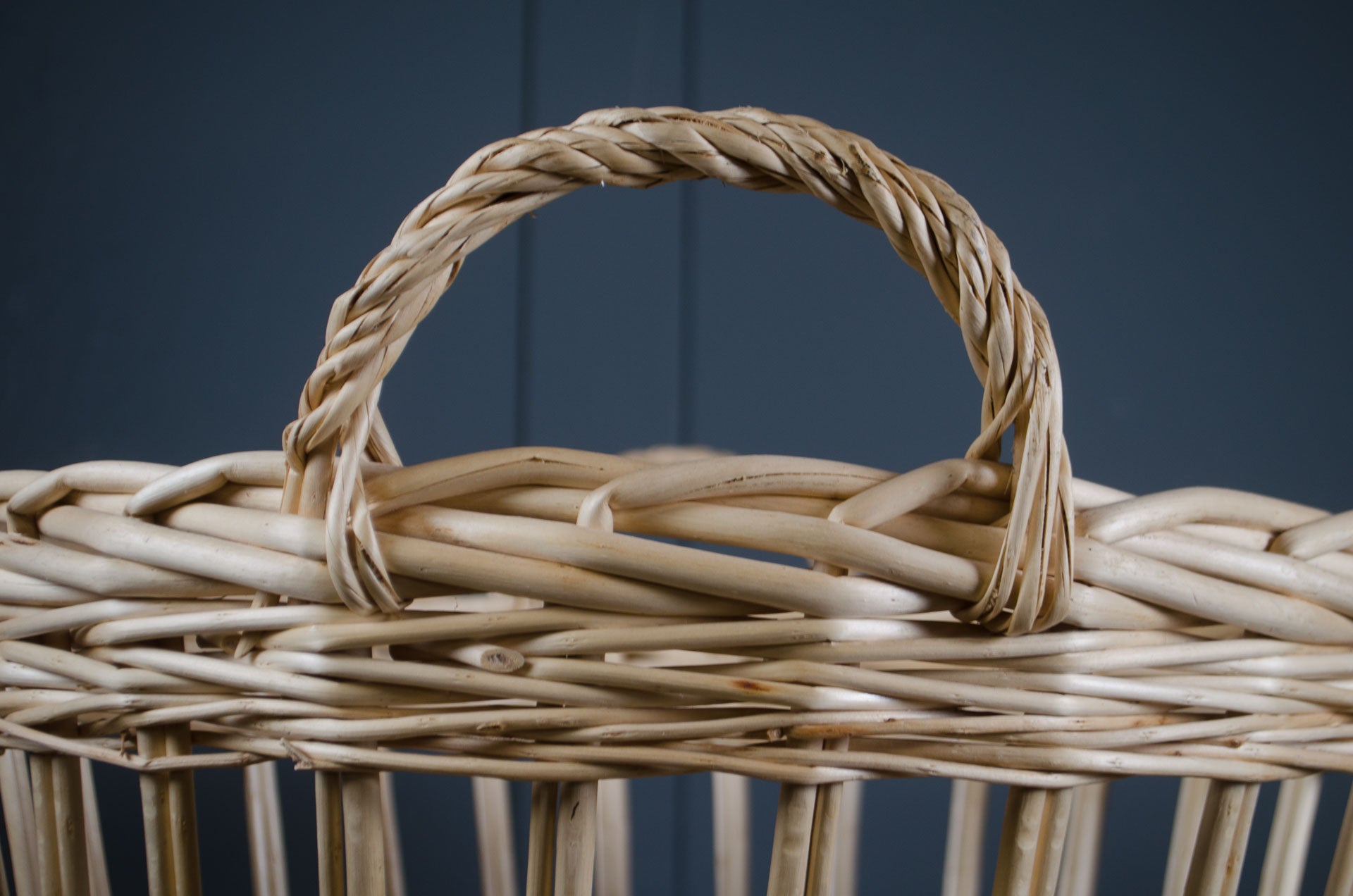 
Close-up of a woven basket with a handle against a dark background